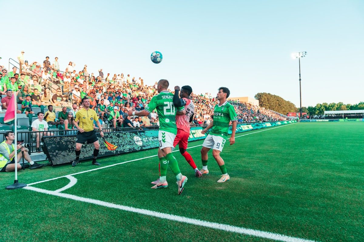 Players and the ball in the air, just feet from the Corner Club seats