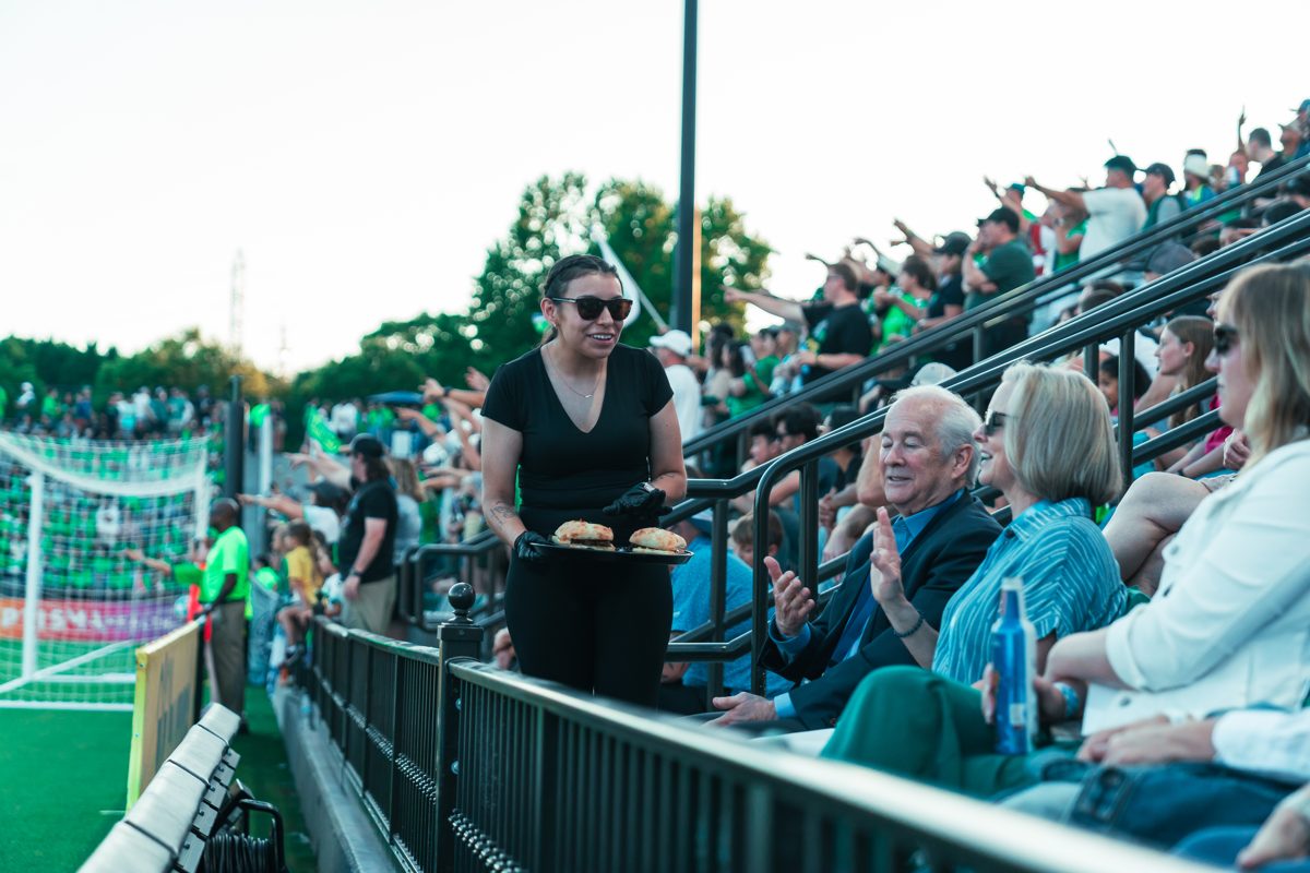 A dedicated waiter serving food to guests at their seats